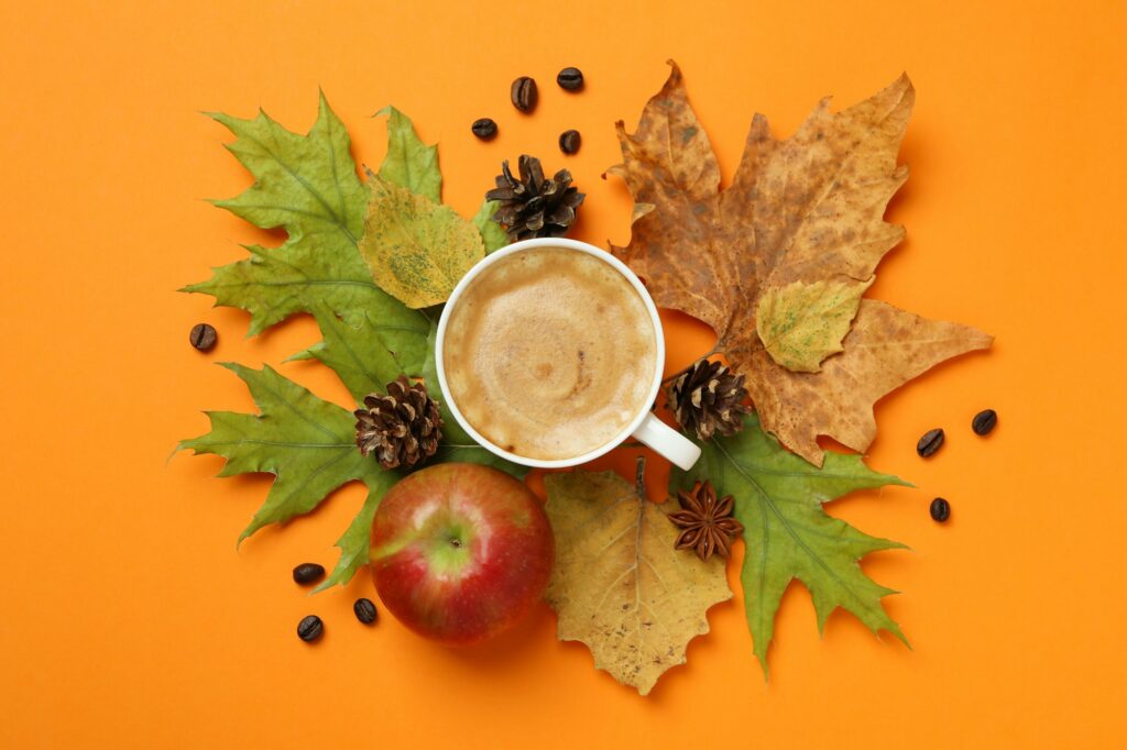 Cozy autumn concept background with coffee drink