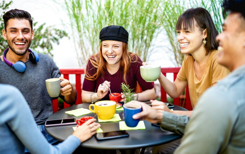 Diverse people group drinking latte at coffee bar garden